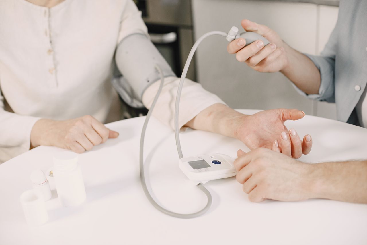 Services Close-up of blood pressure measurement at home highlighting healthcare equipment.